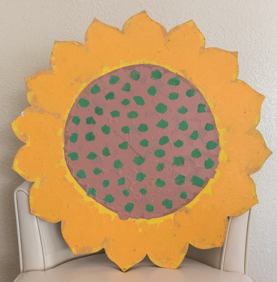 Sunflower is an original wood-painted sculpture measuring 23 × 23 inches, completed in 1990 by American Expressionist Landscape painter Bud Holman.