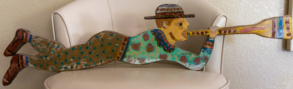 Bugle Boy is an original wood-painted sculpture measuring 9 × 36 inches, completed in 1990 by American Expressionist Landscape painter Bud Holman.